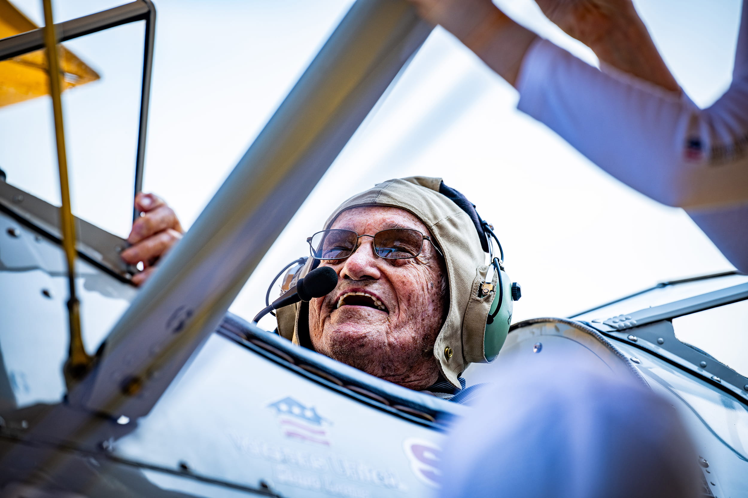 an elderly man in a WWII-era plane