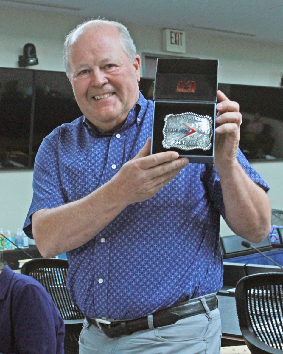a man displaying a custom belt buckle