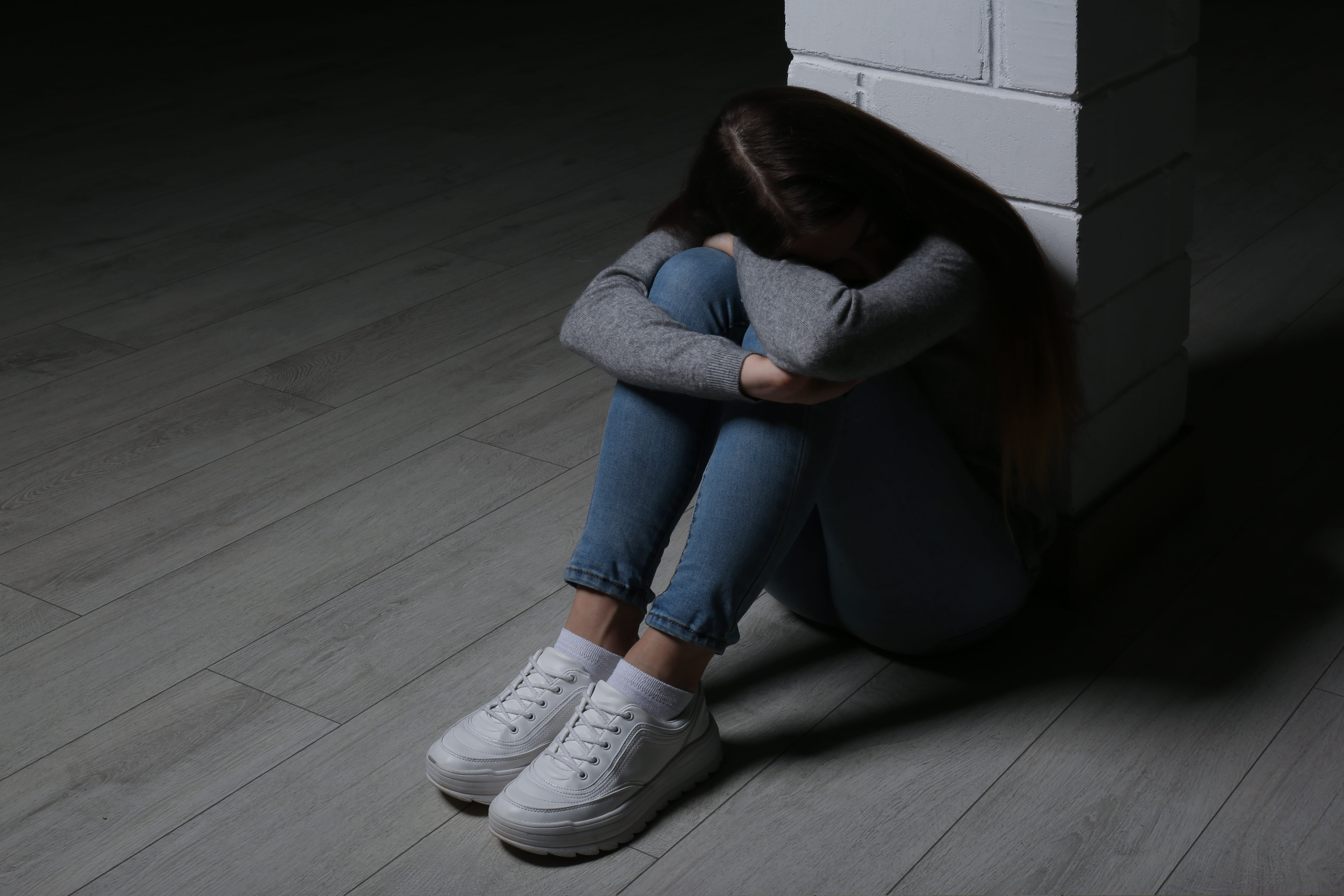 a teenage girl with her head in her hands