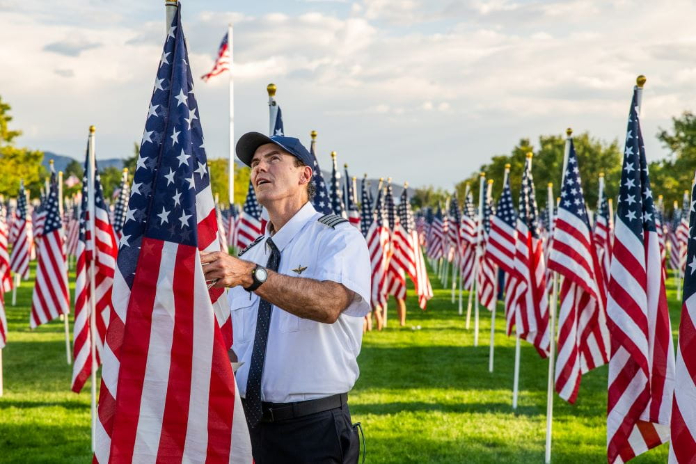 a pilot in a field of American flags