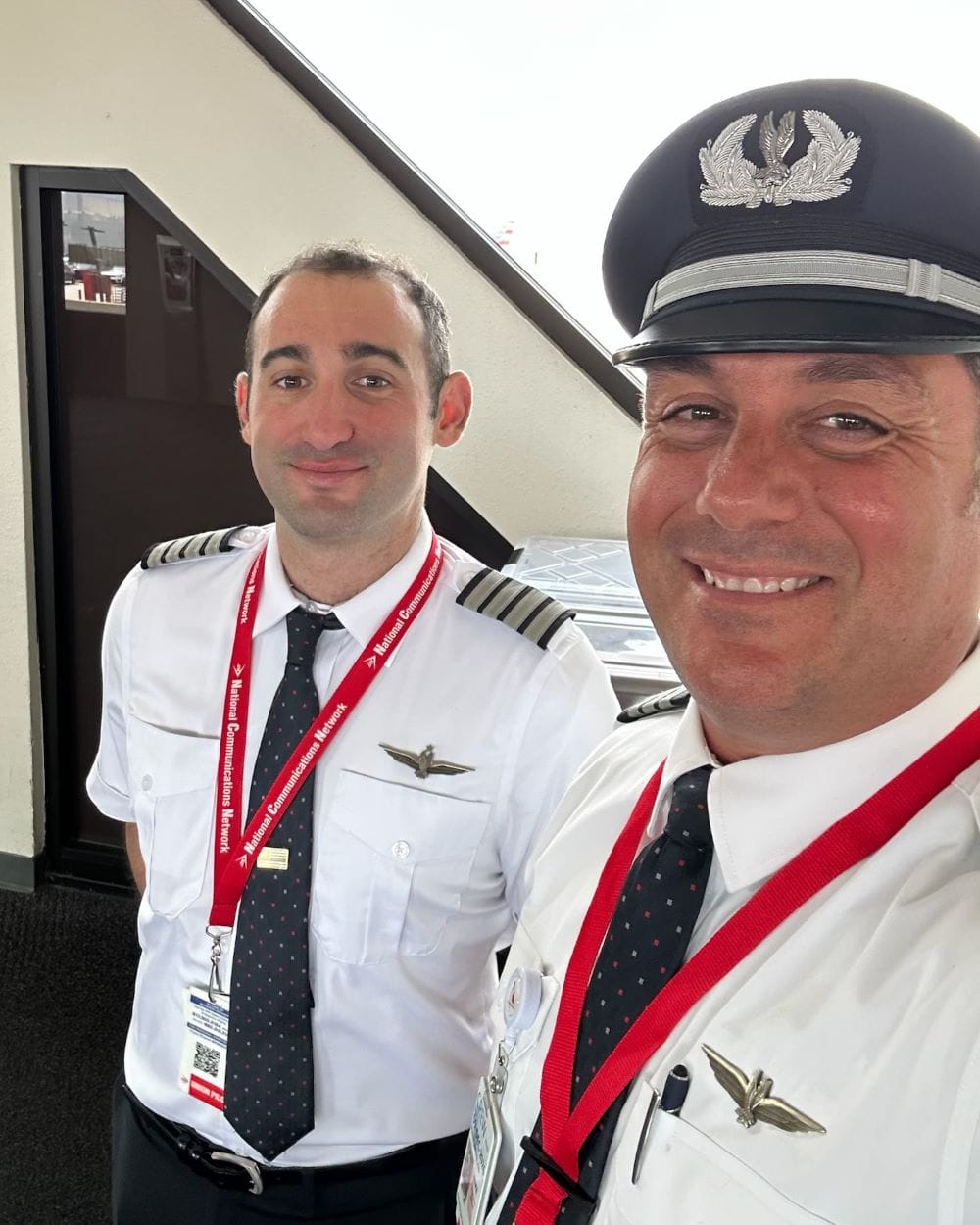 a closeup of two smiling pilots