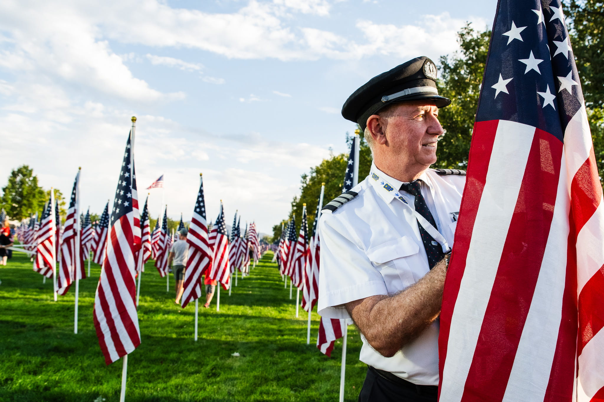 a pilot in a field of American flags